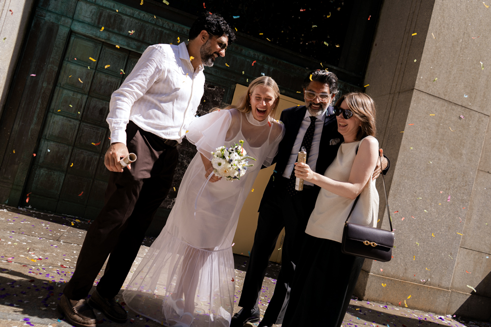 photo of bride and groom exiting with their guests for their new york city hall wedding, stef reyes photo