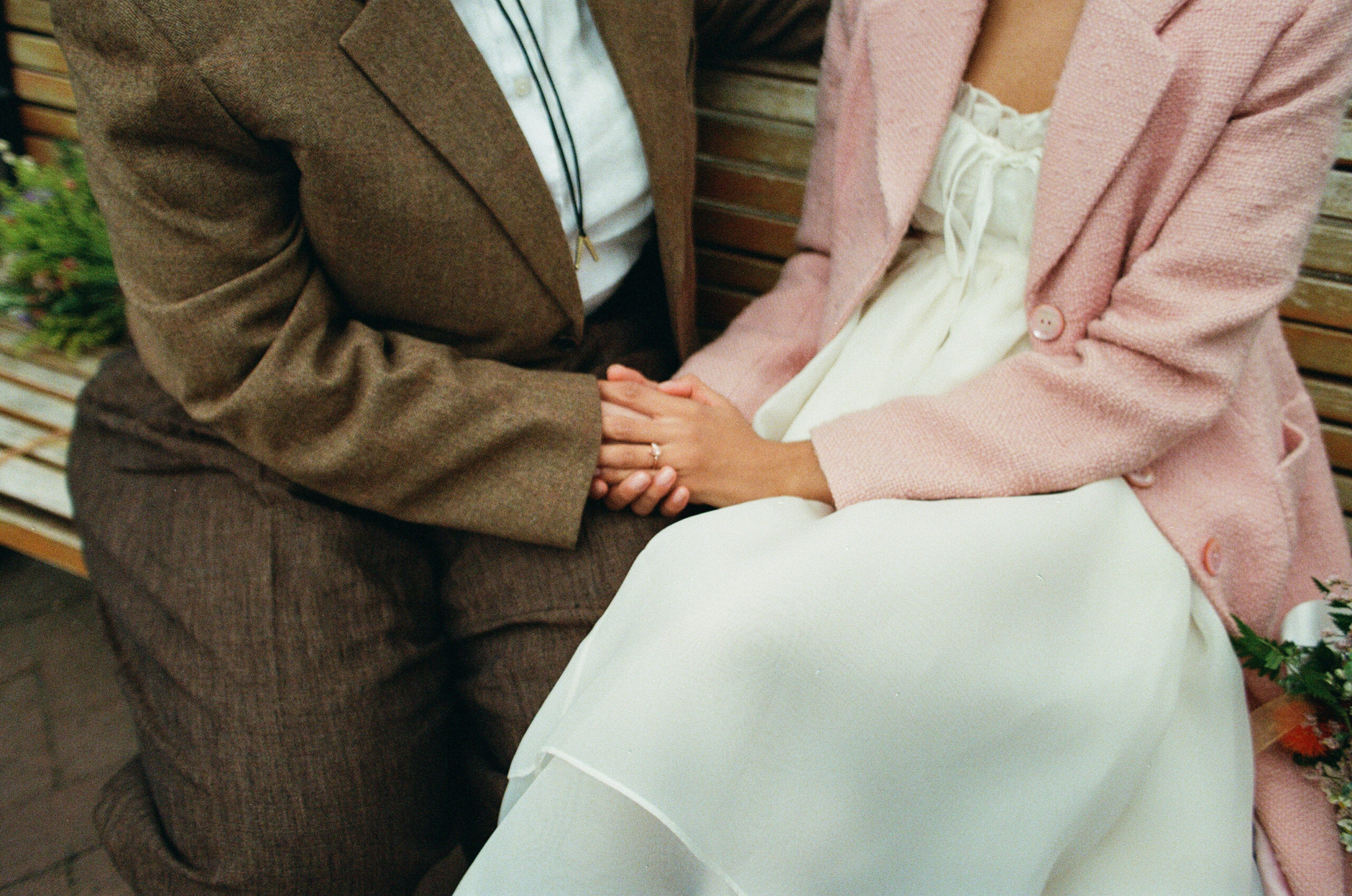 Couple holding hands while on a bench outside of manhattan city hall, stef reyes photo