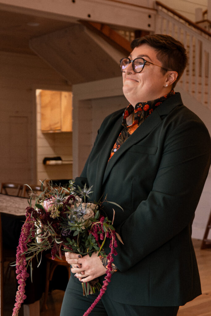 queer couple walks down the aisle during a micro wedding in a barn taken by stef reyes photo 