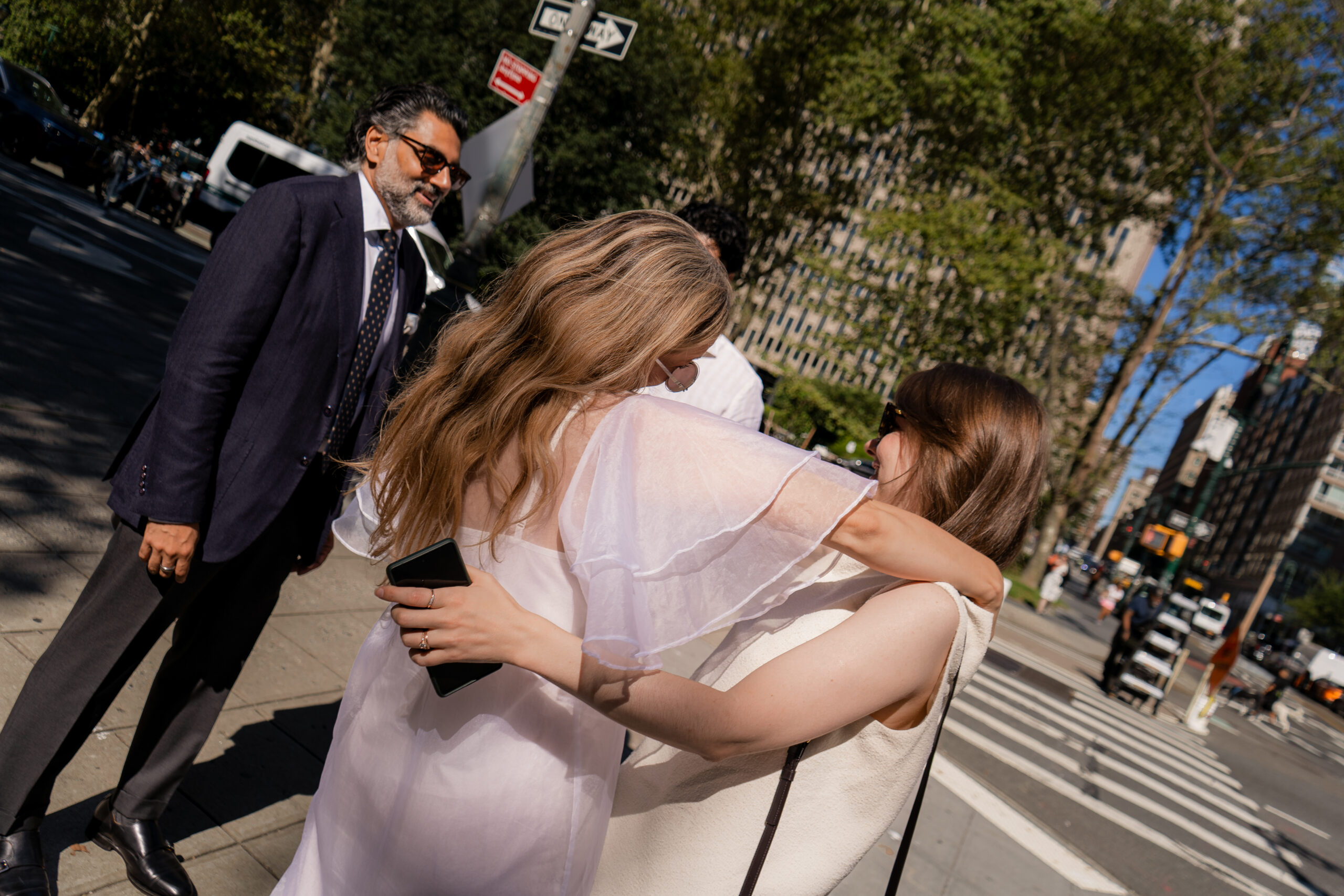 Photo of groom and bride with their guests at city hall manhattan, classic green couch